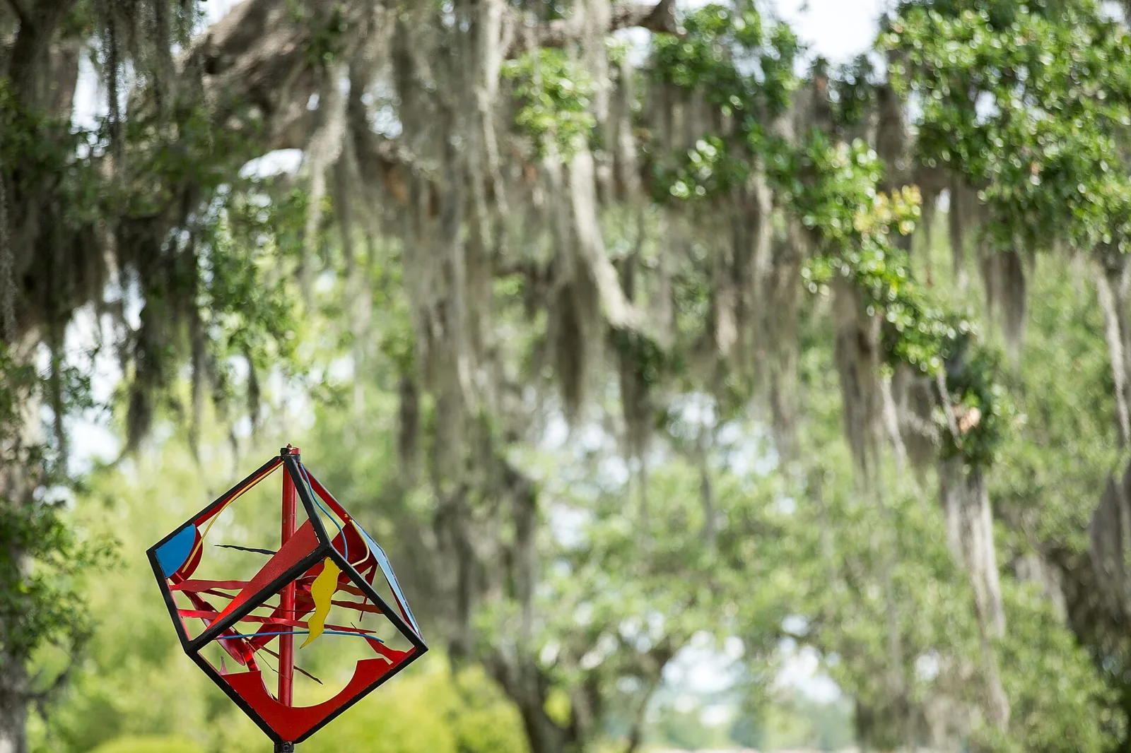 Cubes in Motion by Hanna Jubran, an entry in North Charleston's National Outdoor Sculpture Competition and Exhibition, under live oaks.