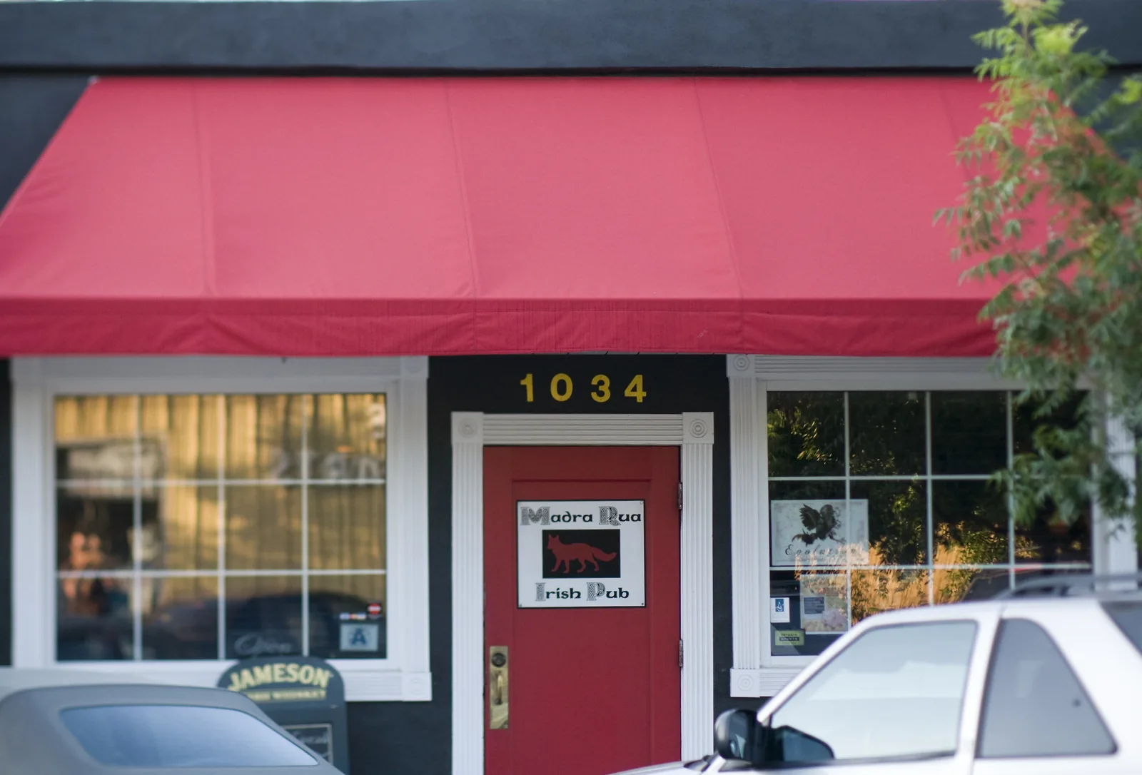 The red door and awning of Madra Rua Irish Pub at 1034 E. Montague Ave. in North Charleston's Olde Village.