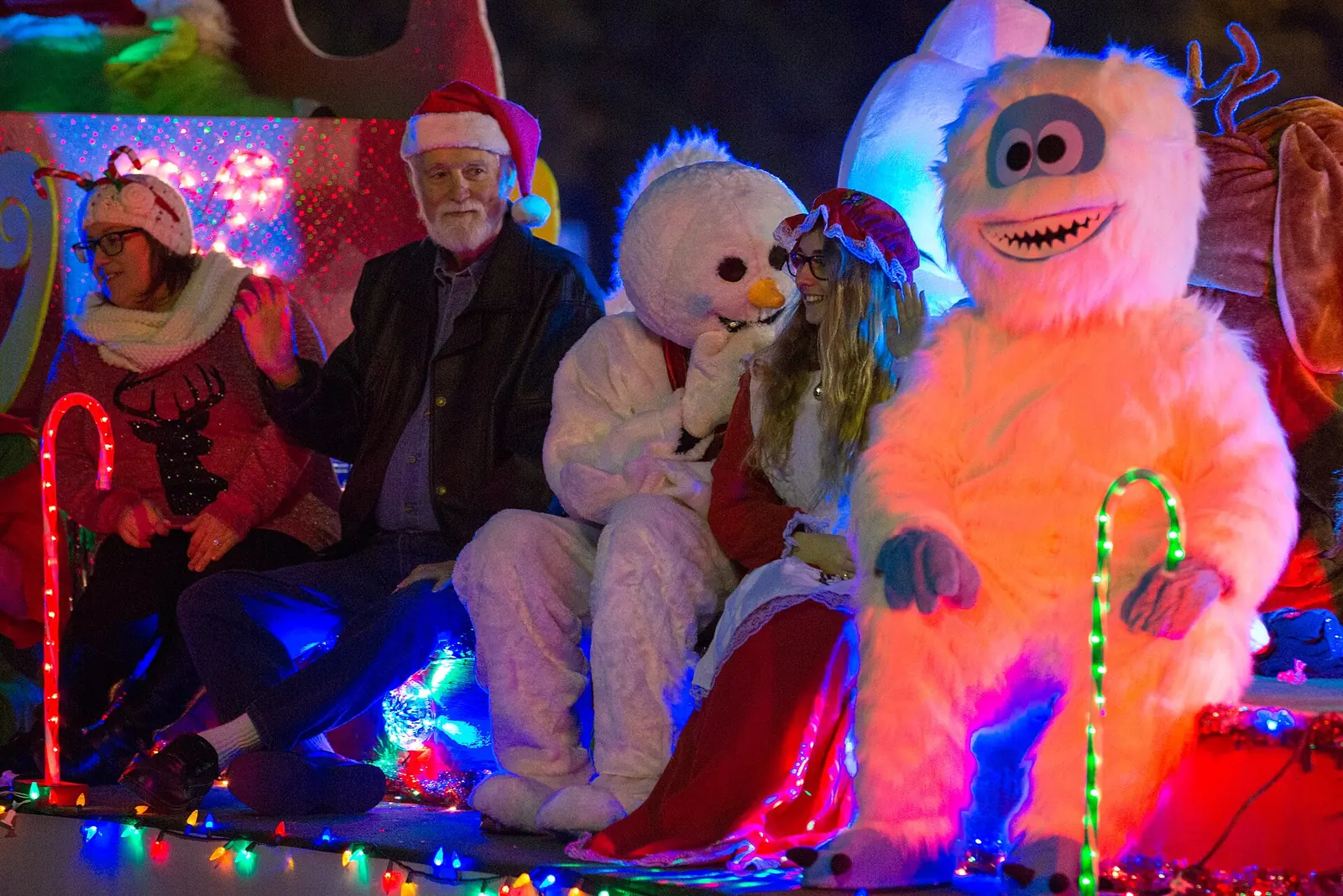Costumed characters ride a lighted float in the North Charleston Christmas Parade at Park Circle.
