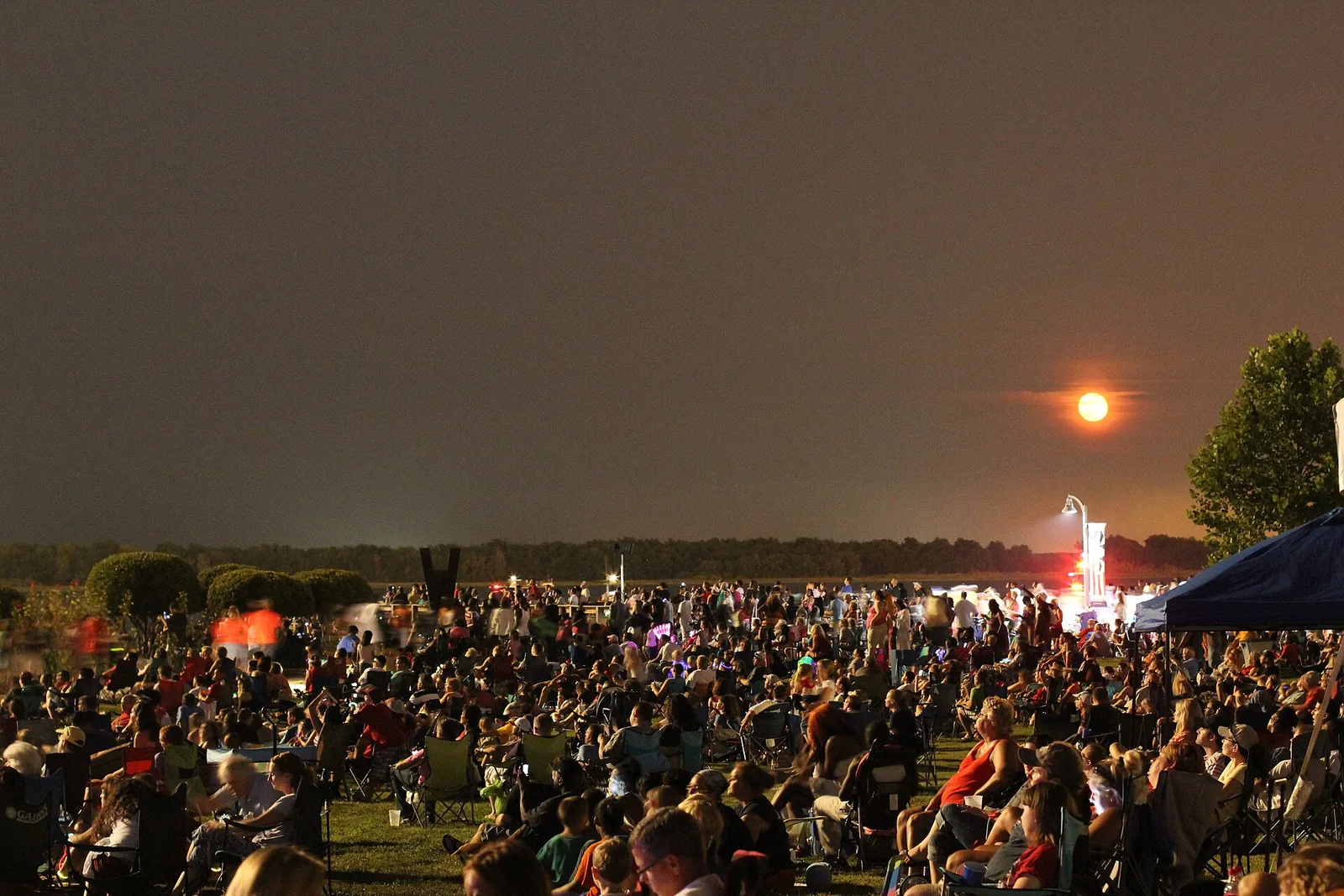Crowds gather on the lawn at Riverfront Park at dusk before North Charleston's Fourth of July fireworks.