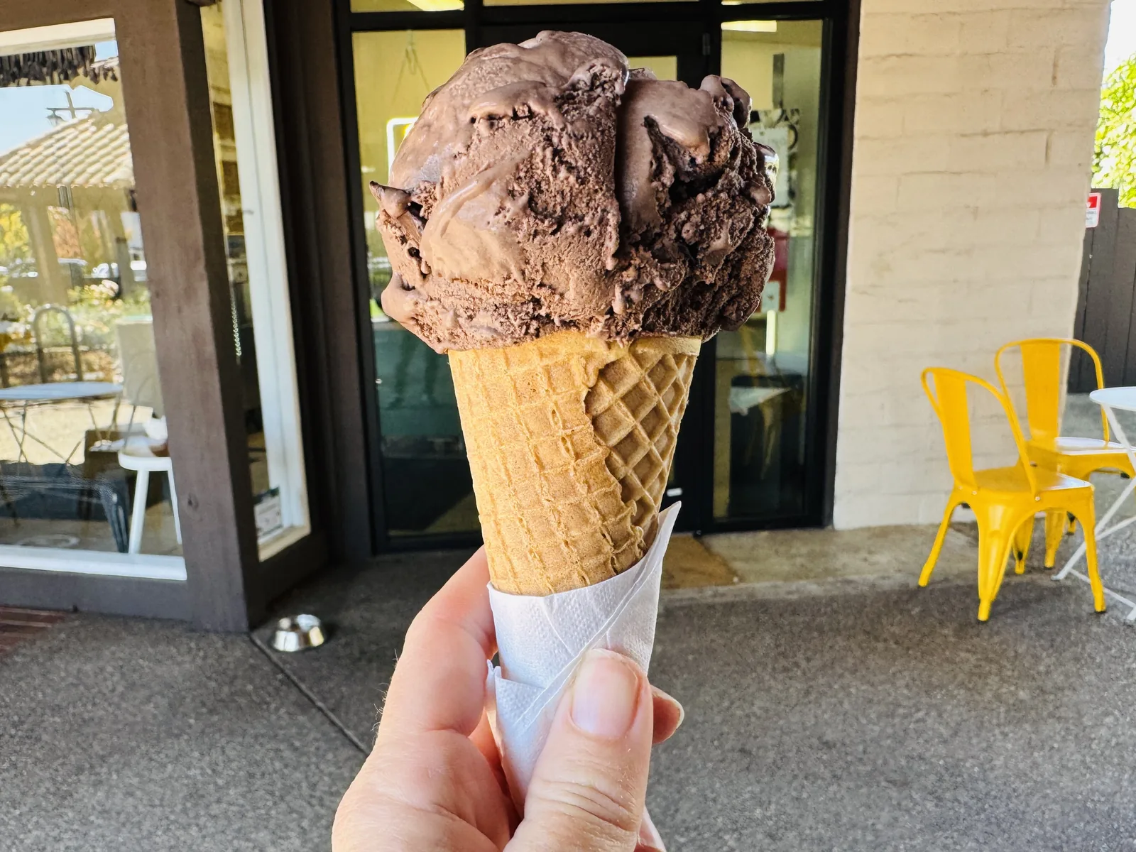 A scoop of dark chocolate chip ice cream on a cone outside an ice cream shop. The photo was taken in Sonoma, Calif., not in North Charleston.