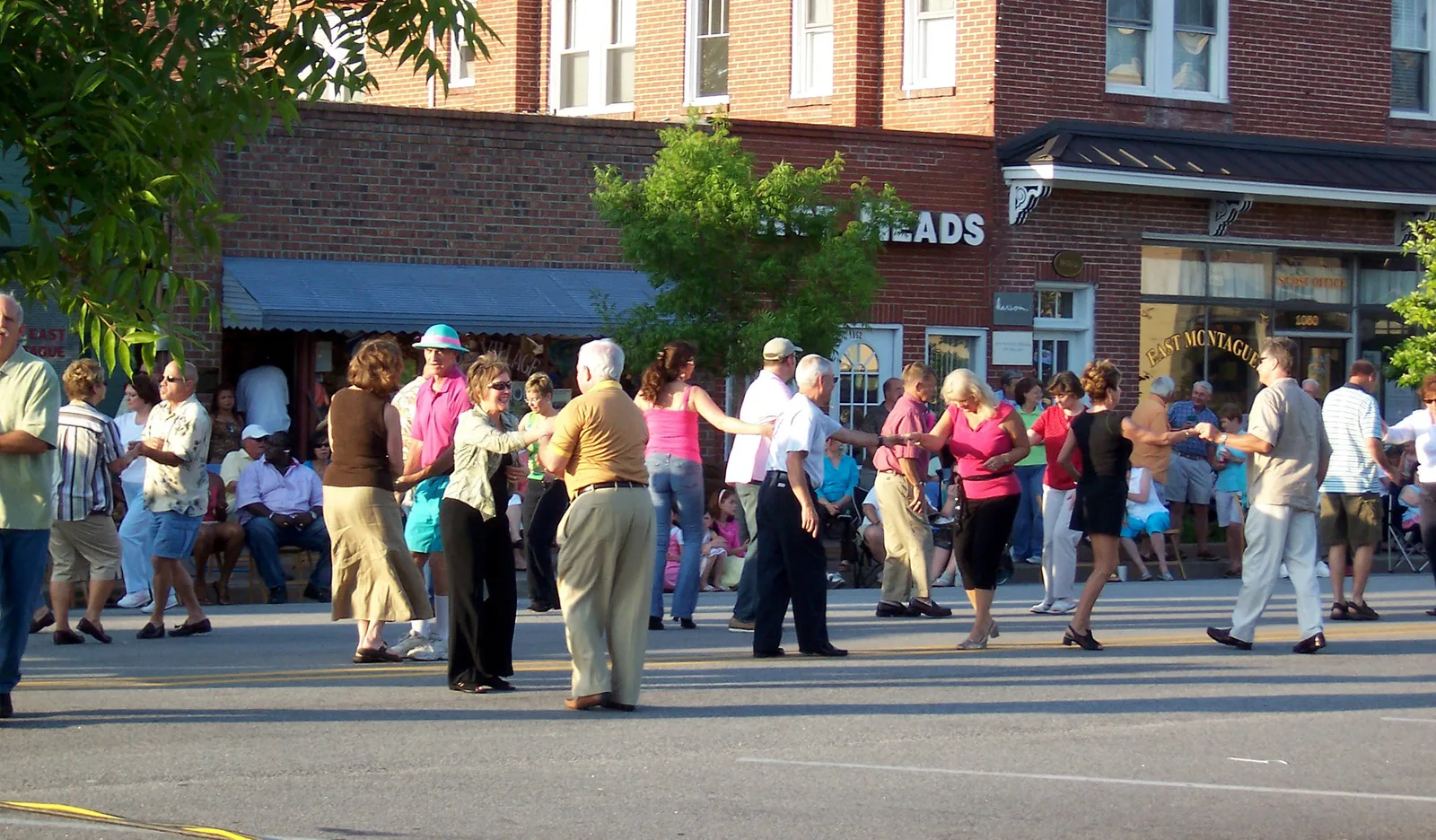Couples dance in the street outside the shops of East Montague Avenue during an Olde Village street dance in North Charleston.