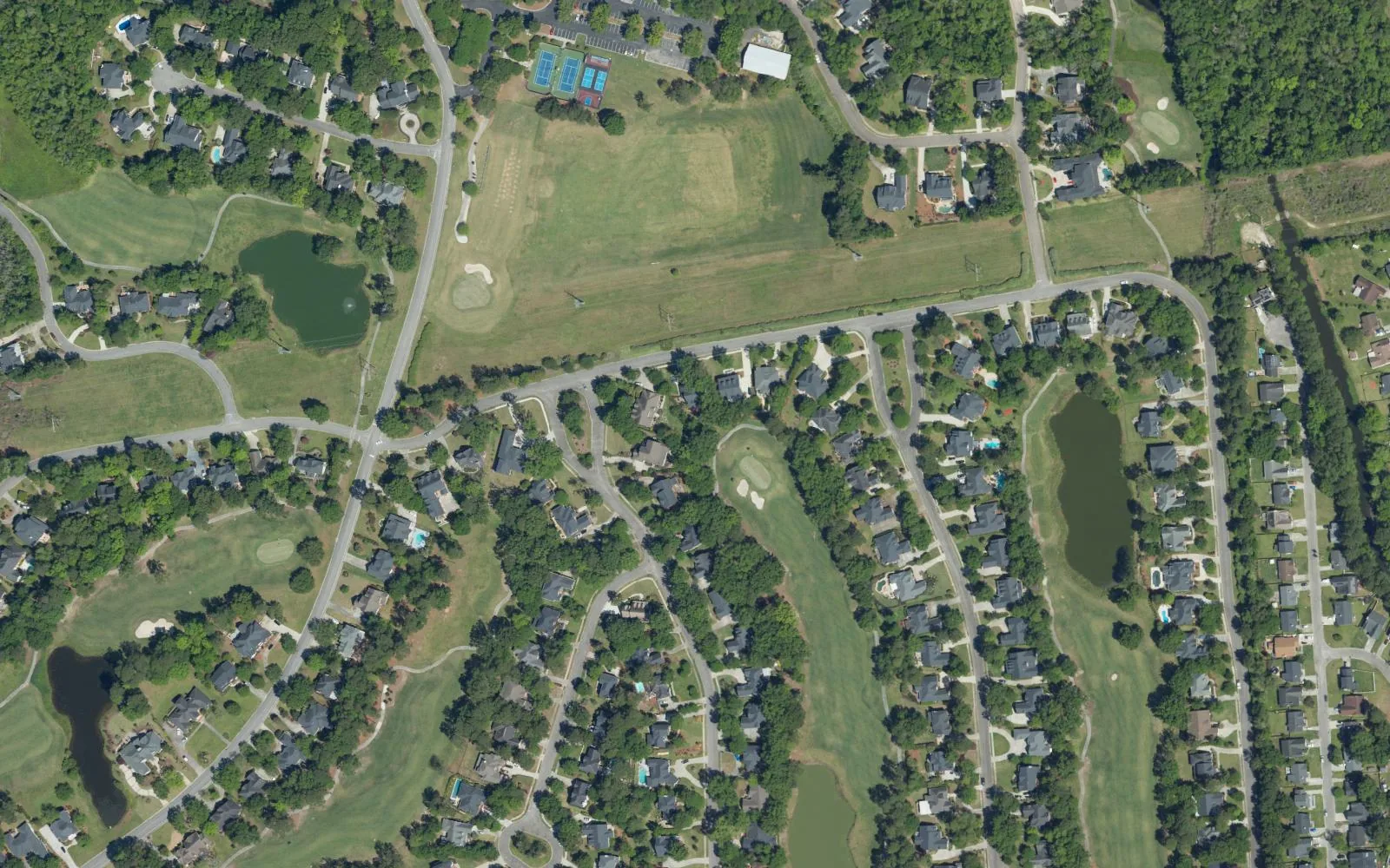Aerial view of Coosaw Creek in North Charleston, with homes along the golf course fairways and ponds.