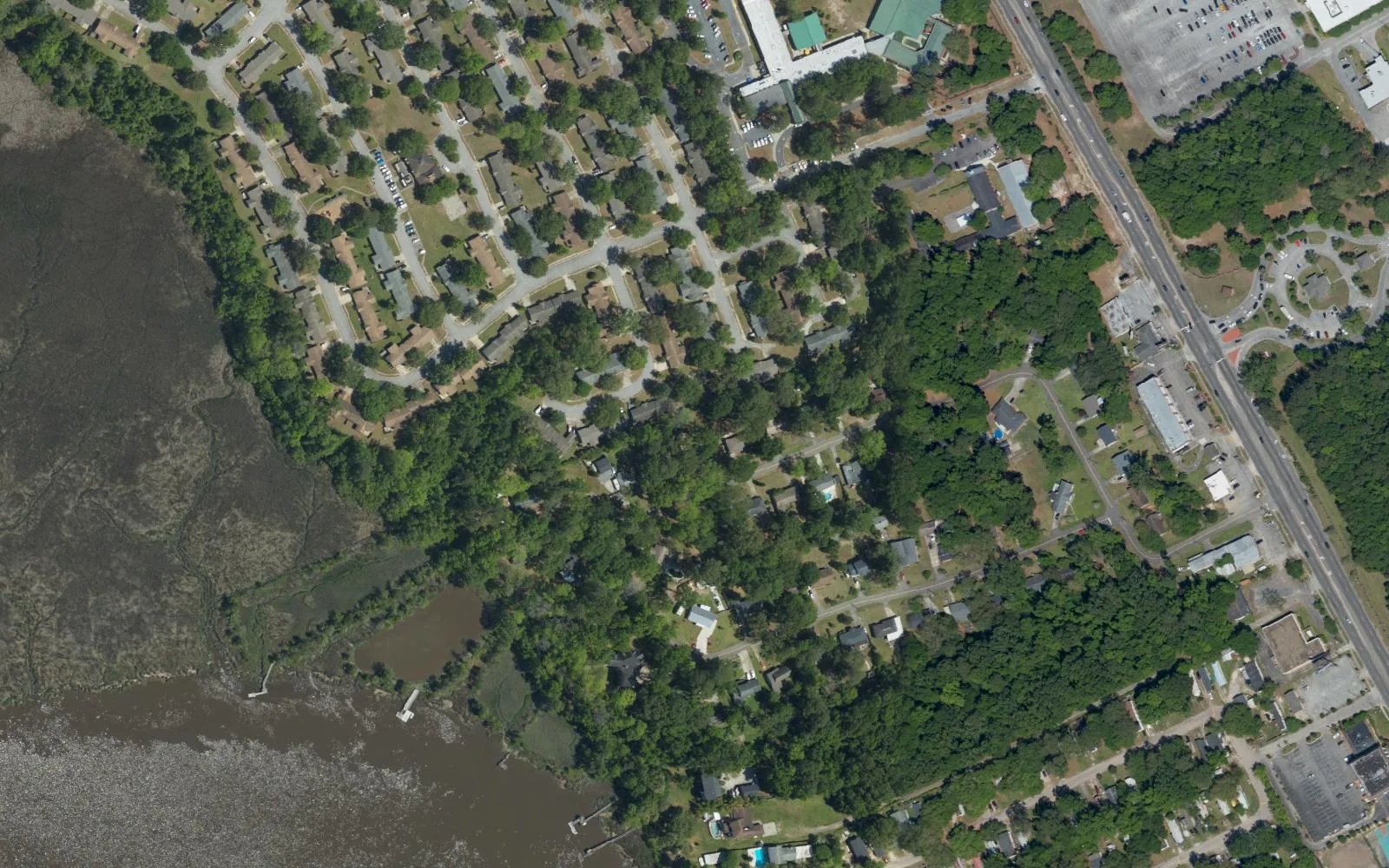 Aerial view of Hunley Park in North Charleston, where neighborhood streets meet the marsh along the Ashley River.