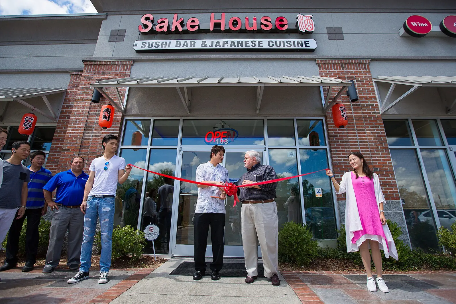 Owners and city officials cut the ribbon at the opening of a new sushi restaurant in North Charleston.