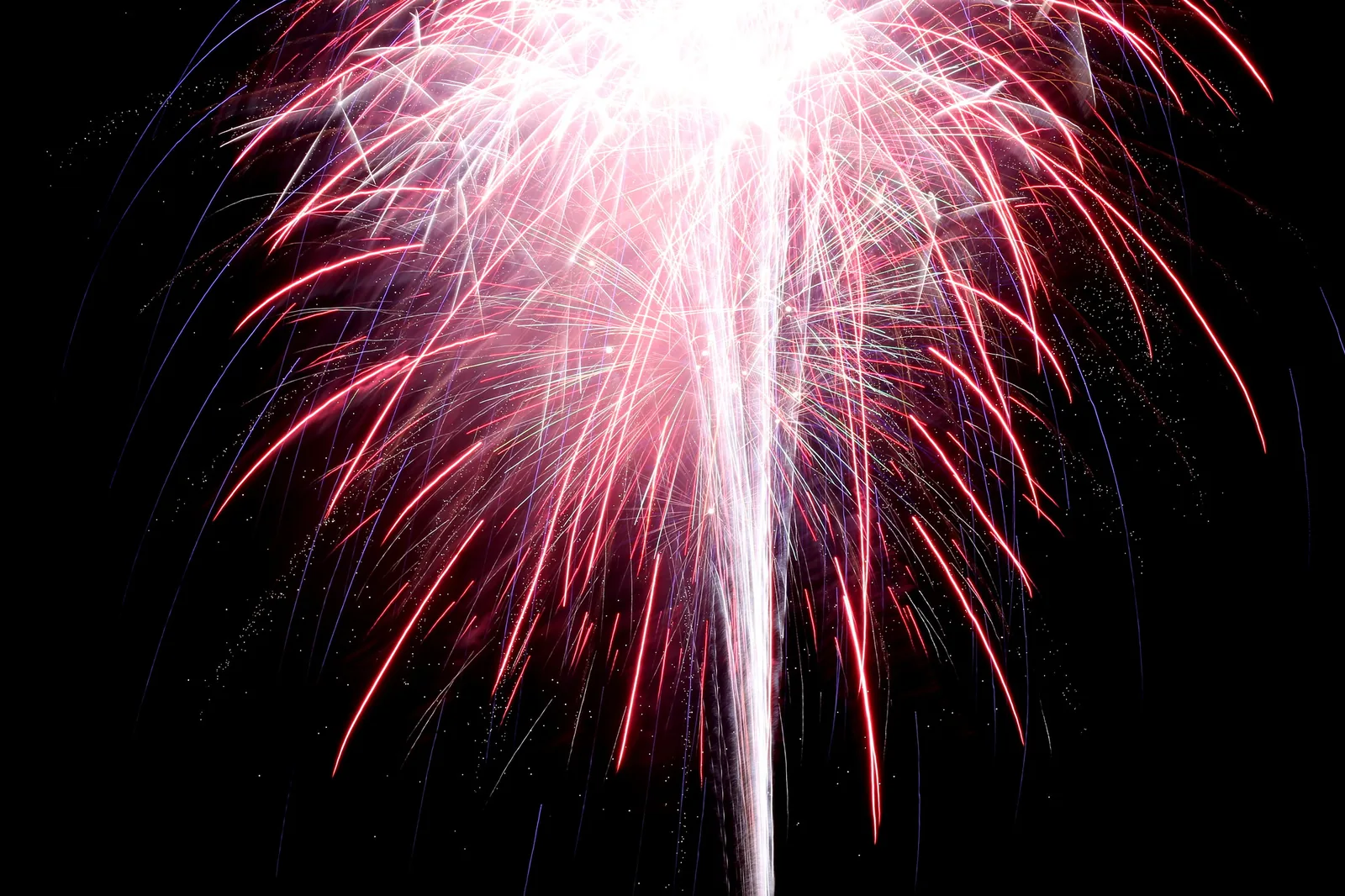 Red and white fireworks burst in the night sky over Riverfront Park in North Charleston.
