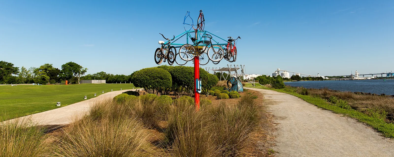 A path runs past a bicycle sculpture and the marsh along the Cooper River at Riverfront Park in North Charleston.