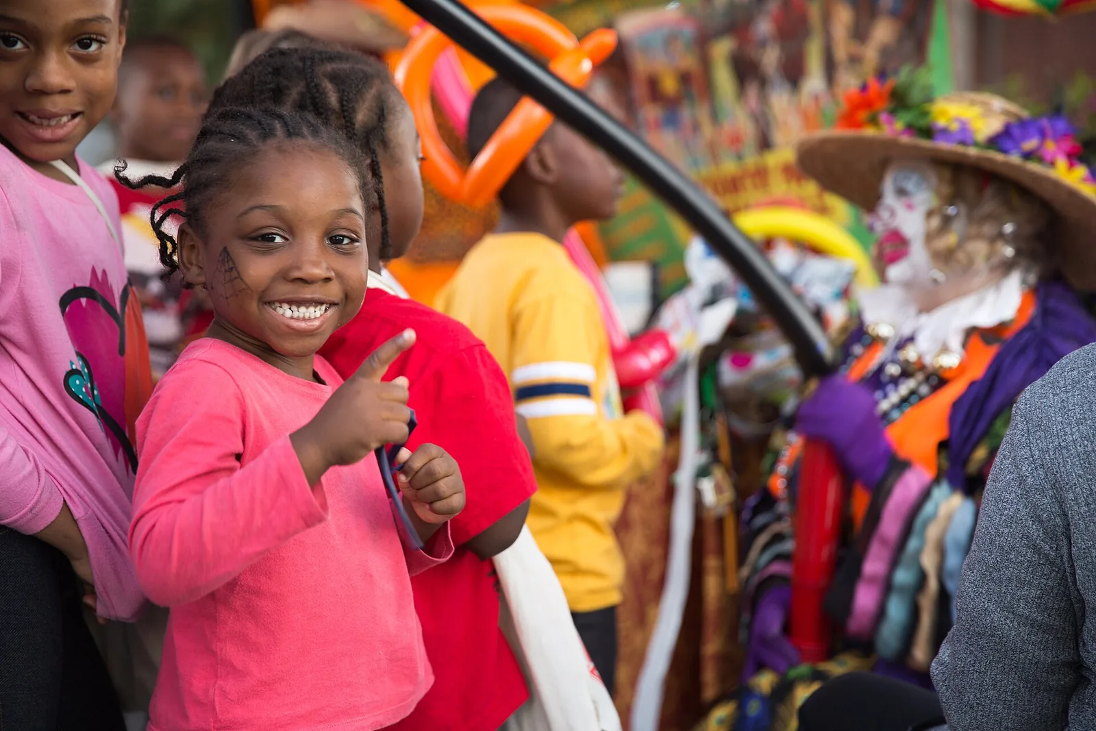 A girl in face paint gives a thumbs-up at the North Charleston Harvest Festival on East Montague Avenue.