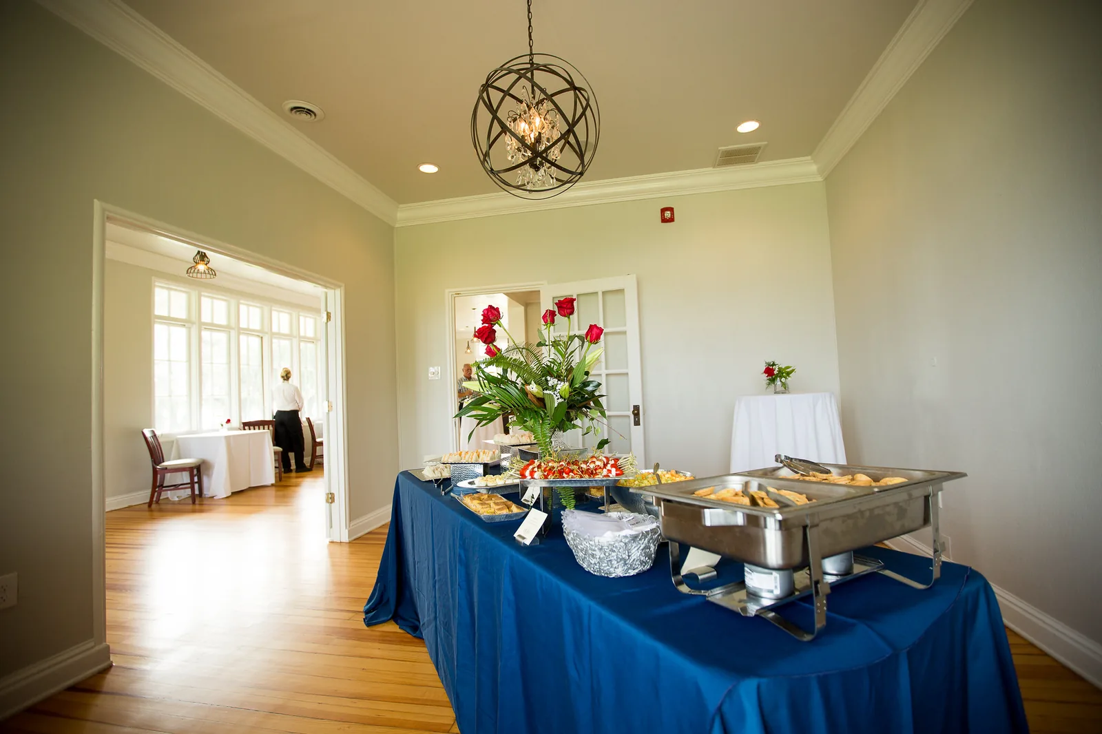 Red roses and a buffet table set out in a reception room at the restored Navy base chapel at Riverfront Park in North Charleston.